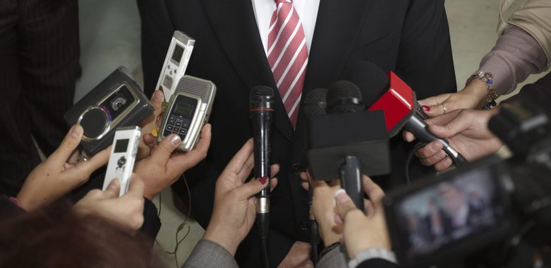 close up of conference meeting microphones and businessman