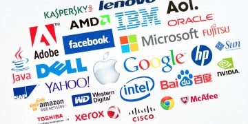 KIEV, UKRAINE - MAY 22, 2014: A logotype collection of well-known world top companies  of computer technologies on a monitor screen. Include Google, Apple, Microsoft, IBM, Adobe, Intel and other logo.